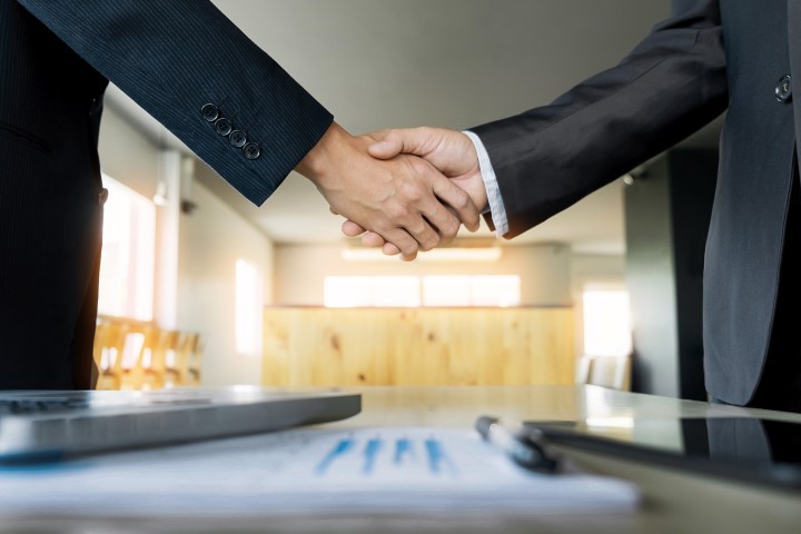 two confident business man shaking hands during meeting office success dealing greeting partner concept 720x480 1